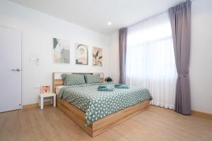 a bedroom with a bed and a window at 2BR Homey townhome 350M walk to Kata Beach Fully equipped in Kata Beach