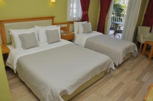 Postel nebo postele na pokoji v ubytování Hotel Doruk