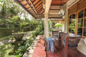 a patio with a table and chairs on a house at Artini 2 Cottage Ubud in Ubud