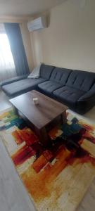 a living room with a couch and a coffee table at Apartament Blaj in Blaj