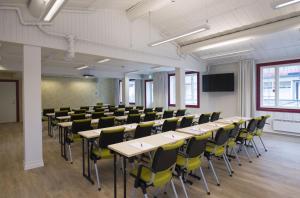 a conference room with tables and chairs and a screen at Thon Hotel Hallingdal in Al