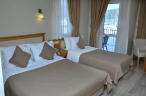 Postel nebo postele na pokoji v ubytování Hotel Doruk
