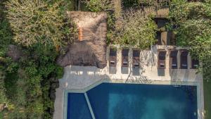 an overhead view of a swimming pool with trees at Artini 2 Cottage Ubud in Ubud