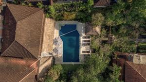 an overhead view of a house with a swimming pool at Artini 2 Cottage Ubud in Ubud
