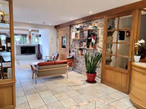 a living room with a stone wall at Hotel Restaurant Txistulari in Itxassou