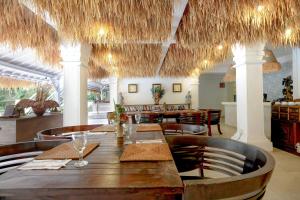 a dining room with a table and chairs and ceilings at Artini 2 Cottage Ubud in Ubud