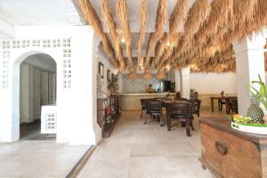 a kitchen and dining room with a table and chairs at Artini 2 Cottage Ubud in Ubud
