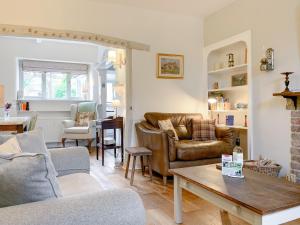 a living room with a couch and a table at Cherry Cottage in Gargrave