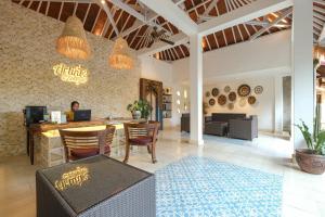 a lobby of a restaurant with a table and chairs at Artini 2 Cottage Ubud in Ubud