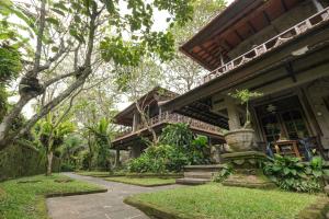 a house with a pathway in front of it at Artini 2 Cottage Ubud in Ubud