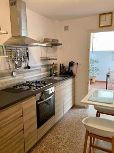 a kitchen with a sink and a stove top oven at Piles Playa Beach Apartment in Piles