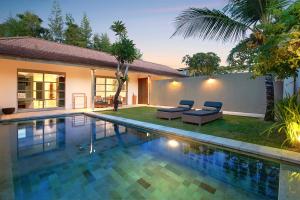 a swimming pool in the backyard of a villa at Uma Sapna in Seminyak