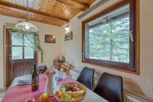 een eetkamer met een tafel met een fruitschaal bij Rozi's Riverside Cottage - Happy Rentals in Osilnica