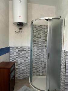 a bathroom with a shower with a glass door at Casa di Maria in Diamante +6 photos