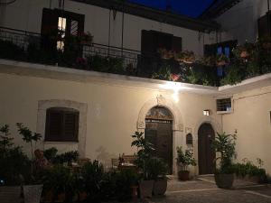 a building with plants on the balconies and a door at B&B Donna Livia in Cantalupo nel Sannio