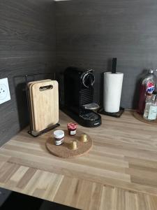 a counter top with a coffee maker and a microwave at La maison Baz in Deauville