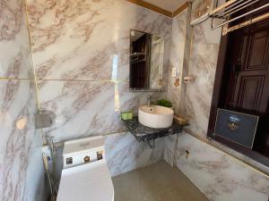 a marble bathroom with a sink and a toilet at Centralhome 2 in Plei Brêng +77 photos