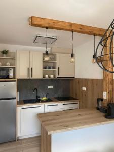 a kitchen with white cabinets and a wooden counter top at Apartma Mango in Bled
