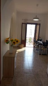 a living room with a vase of flowers on a table at Korali in Symi