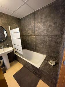 a bathroom with a bath tub and a sink at Spirit of Mar Menor in Torre-Pacheco