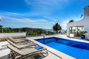 a villa with a swimming pool and a house at Villa Sa Rota Family in San Antonio