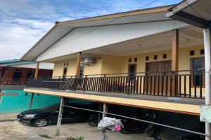 a car parked in front of a house at SPOT ON 92544 Senja Homestay in Balikpapan