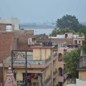 a group of buildings with a river in the background at Azure Family Paying Guest House in Varanasi