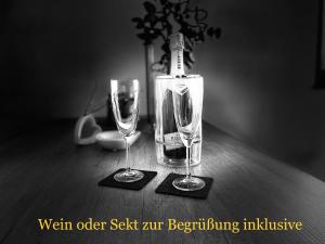 two empty wine glasses sitting on a wooden table at #NEU l Seeblick l NETFLIX l BOXSPRING l NESPRESSO l e-TÜR l Terrasse l 82m2 in Ulmen +10 photos