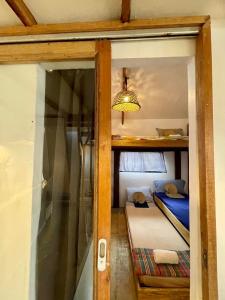 a room with two bunk beds and a glass door at Casita Francisco Siargao in General Luna