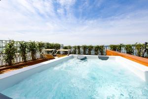 a hot tub on the roof of a house at Hotel Flaminia in Sirmione