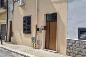 a building with a brown door on the side of a street at casetta arianna in Brindisi