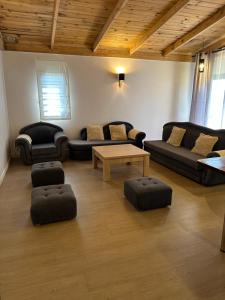 a living room with couches and a coffee table at Flora Hotel Ivato International Airport in Antananarivo