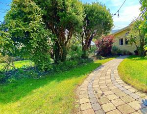 a brick path in front of a house at Duck Lodge B&B with Hot Tub in Pyecombe