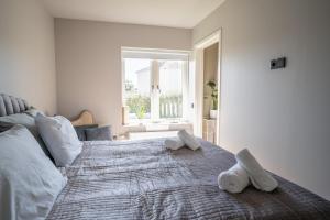 a bedroom with a large bed with towels on it at Hotell Hanöhus Hällevik in Sölvesborg