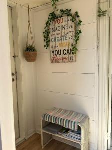 a room with a bench and a wall with a wreath at 5 minute walk to Lego house - private studio apartment with Garden in Billund