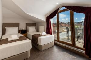 Postel nebo postele na pokoji v ubytování Baymari Suites Design Florya