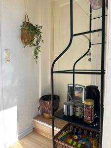 a shelf in a room with some items on it at 5 minute walk to Lego house - private studio apartment with Garden in Billund