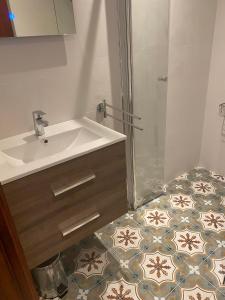 a bathroom with a sink and a shower at Studio Don Jim Family, Beautiful luxurious new Studio near Arenal beach in Jávea