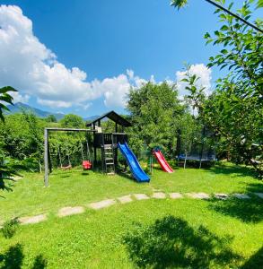 a playground with two slides and a swing at Agropa Garden in Bistriţa