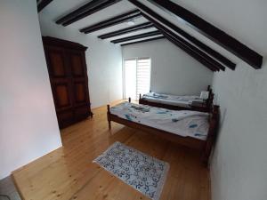 a bedroom with two beds in a room with a window at Vila Bogicevic in Nova Varoš