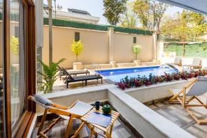 a patio with chairs and a swimming pool at Baymari Suites Design Florya in Istanbul +37 photos