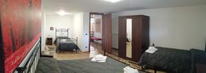 a bedroom with a bed and a room with a hallway at La Casa del Borgo-intero appartamento-cir22158 in Latina