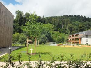 a park with a playground in front of a building at Barrierefreies Apartment Ursulinenhof in Oberried