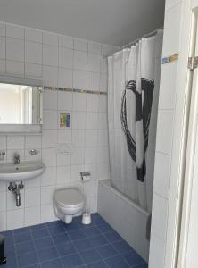 a bathroom with a toilet and a sink at Appartamento 464 nel CUORE di Locarno con piscina in Locarno