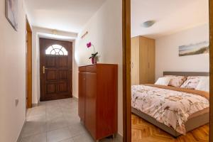 a bedroom with a bed and a wooden door at Bernard Old Town Apartment in Split