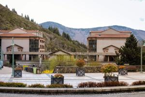 a group of buildings with mountains in the background at AU CHAT BLEU in Saint-Laurent-les-Bains