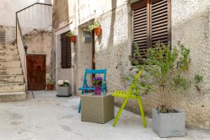 a group of chairs sitting outside of a building at Bernard Old Town Apartment in Split