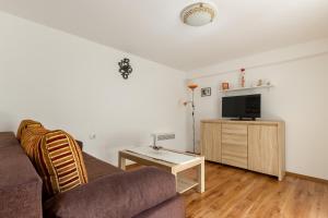 a living room with a couch and a tv at Bernard Old Town Apartment in Split