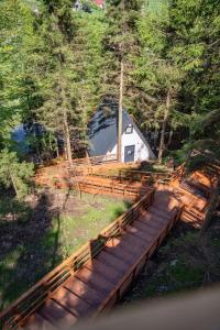 a wooden bridge leading to a cabin in the woods at Montana Suite Bungalows in Akcaabat