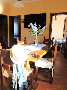 Una mesa de comedor con un jarrón de flores encima. en La Cheta, en Monsagrati